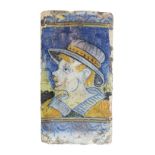 Spanish tile, probably 17th Century, polychrome decorated with the head of a young man, 29.25cm x
