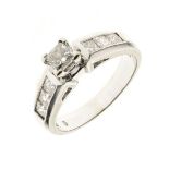 Diamond ring, the white mount stamped '14k', the central Princess cut with a trio of channel set