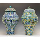 Two large 19th Century pottery vases, probably Northern India, each having a domed cover and with
