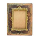 Late 19th Century ormolu and tooled leather picture frame, the ormolu inner decorated with cast