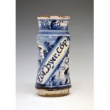 Spanish blue and white painted albarello decorated with a landscape with castle and diagonal script,