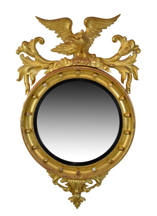 19th Century giltwood convex wall mirror, the circular plate within ebonised reeded surround and