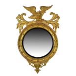 19th Century giltwood convex wall mirror, the circular plate within ebonised reeded surround and