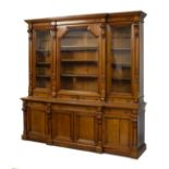 Late Victorian Aesthetic Period oak breakfront library bookcase, the upper stage with dentil cornice