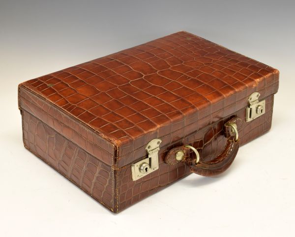 Small early 20th Century crocodile leather suitcase, having nickel plated fittings, makers label for