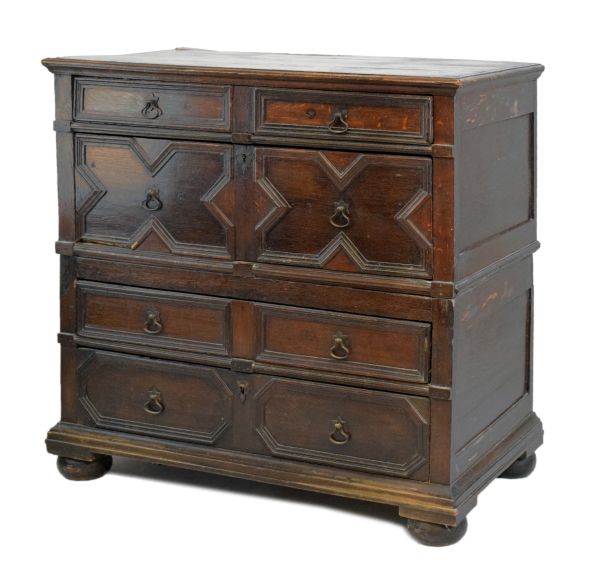 Late 17th Century oak geometric chest of drawers having a planked rectangular top with moulded