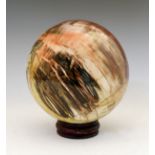 Large petrified wood sphere, probably Madagascar approximately 18cm diameter, with wooden stand