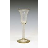 18th Century wine glass, having a bell shaped bowl, air twist stem and standing on a conical foot,