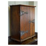 Early 20th Century oak cabinet fitted a tongue-and-groove style door with applied Art Nouveau