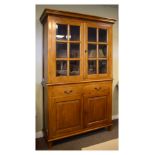 Reproduction walnut finish two section bookcase, the upper fitted a pair of bevelled glass doors,