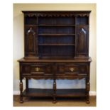 Early 20th Century stained oak dresser, the plate rack fitted pair of panelled doors, the base