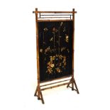 Early 20th Century bamboo framed firescreen having needlework panel of floral design against a black