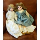 Armand Marseille bisque head doll having blue glass eyes and one other smaller similar