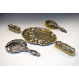 George V silver four piece dressing set with floral decoration comprising: three brushes and a