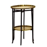 Circular engraved brass two tier occasional table on folding wooden stand, the top 39.5cm diameter