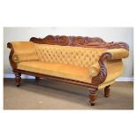 Victorian carved mahogany double scroll-end settee, the foliate scroll back rail over deep-