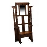 Early 20th Century carved oak hallstand with bevelled rectangular mirror framed by carved uprights