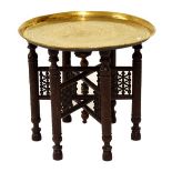 Indian/Middle Eastern brass-topped folding table with six-leg hardwood base with 'Mushribiya'