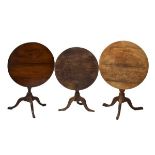 Three George III oak snap-top tripod occasional table, largest 78cm diameter (3)