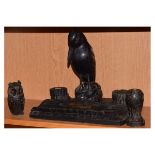 Group of ebonised desk items to include; desk stand formed as tree trunks with pen tray, inkwells