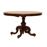Victorian figured walnut oval 'Loo' or centre/breakfast table, the tilting oval top on carved