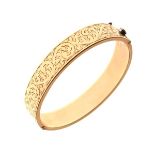 Yellow metal snap bangle with foliate scroll engraved decoration, stamped '9ct Gold Metal Core',