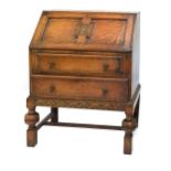 Early 20th Century oak bureau with panelled fall over two drawers on bulbous supports, 73cm wide