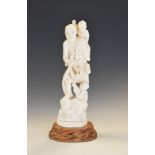 Japanese Meiji period carved ivory okimono modelled as a fisherman with two children, incised lily