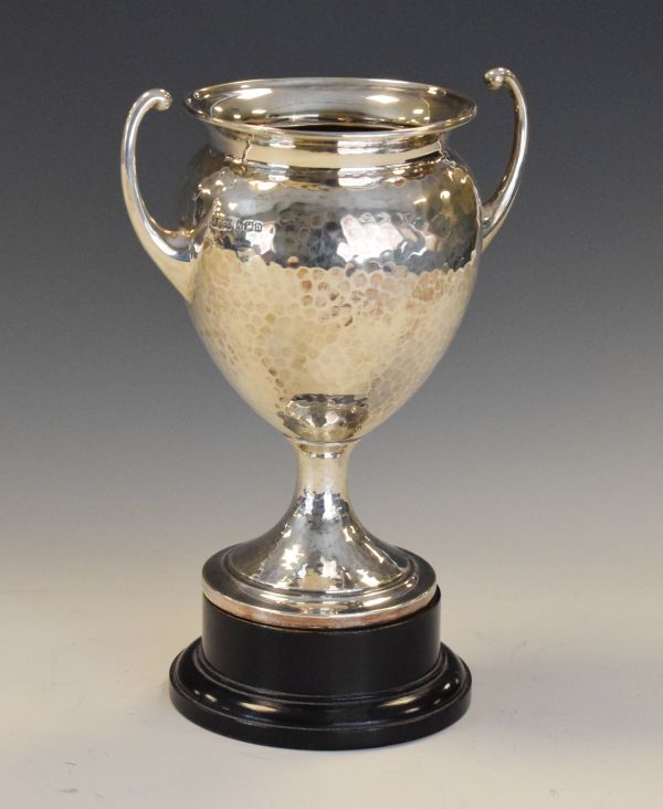 George V silver trophy cup with hammered finish standing on a stepped circular foot, Sheffield 1930,