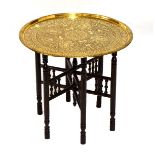 Finely decorated Benares style brass tray and folding stand, 59cm diameter