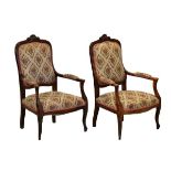 Pair of early 20th Century beech framed Continental style open arm chairs, raised on cabriole