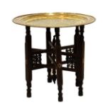 Benares style circular brass tray on folding stand, 57cm diameter