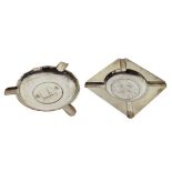 Two white metal Oriental ashtrays, the first inset with a Chinese junk boat silver dollar, the