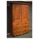 19th Century pitch pine linen press, the upper section fitted one shelf enclosed by a pair of