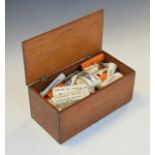 Wooden box containing a large selection of printed confectionery labels etc