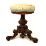 Victorian rosewood revolving music stool, having carved tripod base