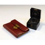 Asprey hide-cased travelling inkwell, the hinged tooled cover with brass swing handle stamped '