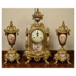 20th Century gilt metal and porcelain-mounted clock garniture, the clock 41cm high, with a pair of