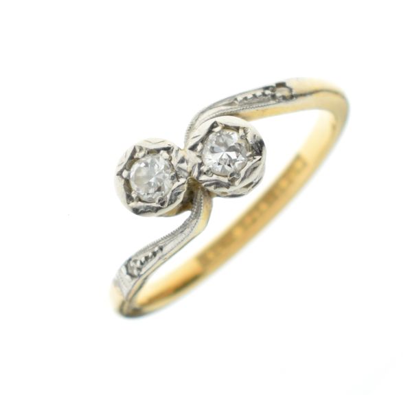 Yellow metal and platinum two-stone diamond ring of crossover design, stamped 18ct and Platinum,