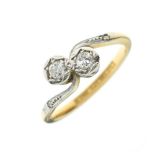 Yellow metal and platinum two-stone diamond ring of crossover design, stamped 18ct and Platinum,