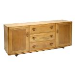 Ercol - Light elm sideboard fitted three drawers flanked by cupboard doors on castors, 156cm wide