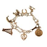 Unmarked yellow metal charm bracelet of fancy-link design set six assorted charms, 13.4g gross