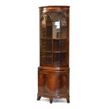 Reproduction mahogany bowfront corner cupboard fitted four shelves, the base enclosed by a