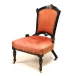 Victorian ebonised salon chair, raised on turned supports, upholstered in salmon pink fabric