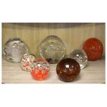 Seven glass paperweights