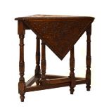 Early 20th Century oak triangular drop leaf corner table having floral carved top, measuring 75cm