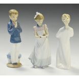 Two Lladro porcelain figures, and a Nao figure of a boy with hands clasped together, the tallest