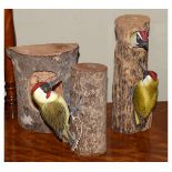 Two painted wooden sculptures of Green Woodpeckers, the larger 28cm high, together with a third