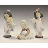 Three Lladro figures - Pair of Geisha and Eskimo, the former standing 19cm high