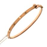 9ct gold snap bangle of textured 'belt' design, 5.1g approx